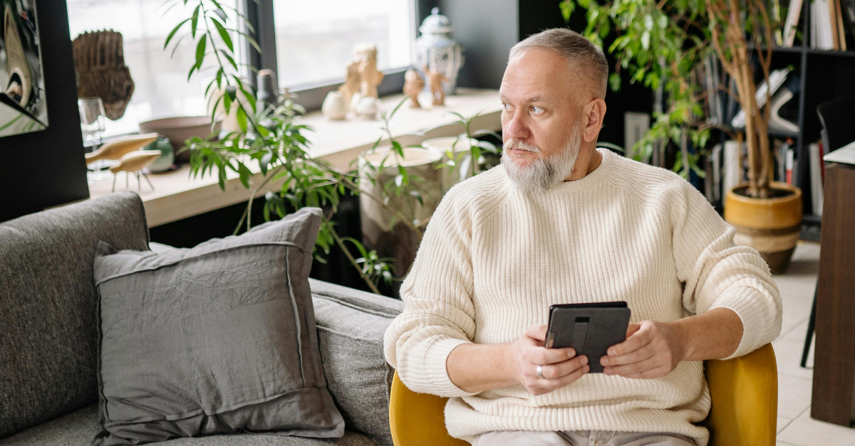 Man on tablet looking away