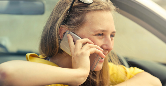 Young woman in open top car