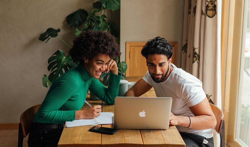 young man and woman looking at laptop