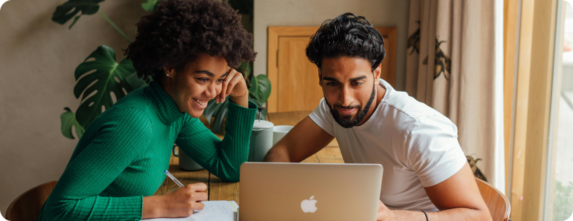 Young man and woman looking at laptop